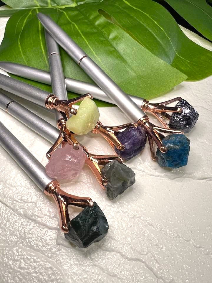 Pen with a crystal, rock or stone topper
