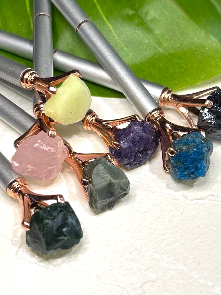Pen with a crystal, rock or stone topper